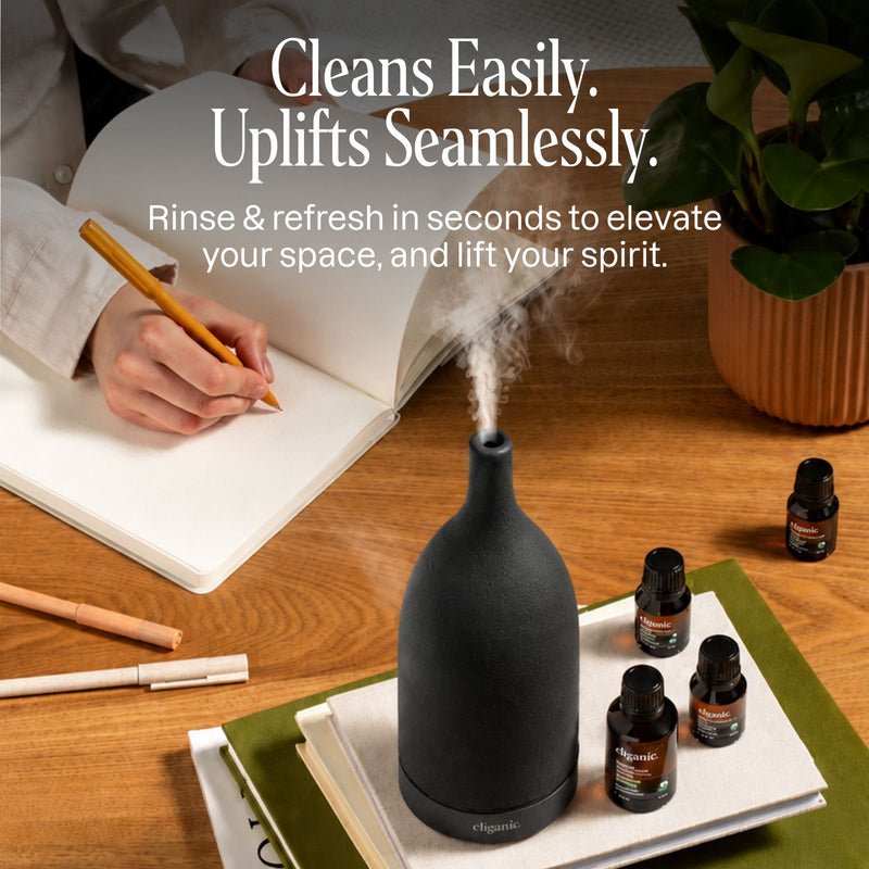 Black ceramic diffuser beside books creating a relaxing home environment