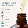 Brown glass bottle with dropper and certification logos on a white background