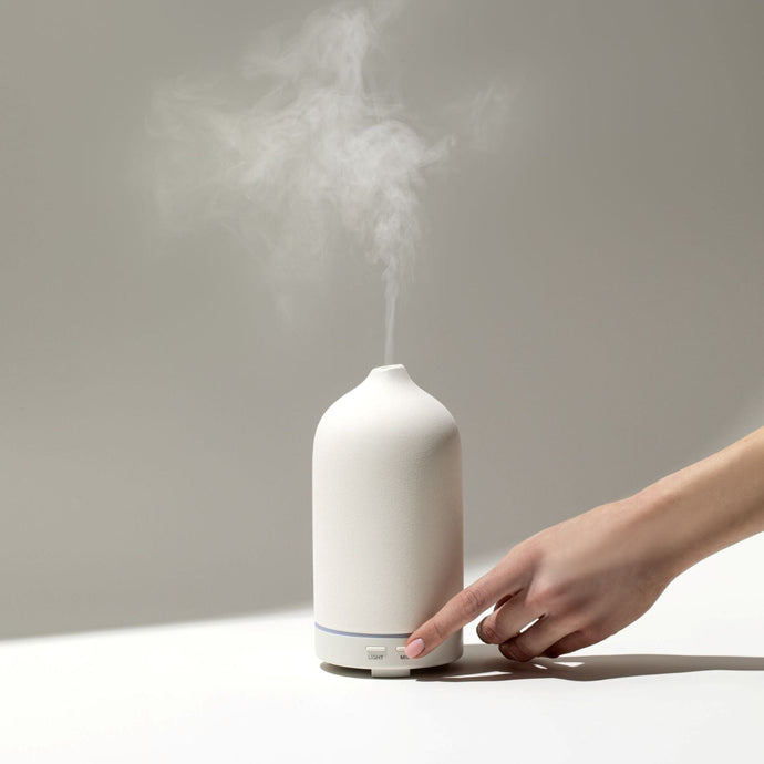 Cliganic ultrasonic essential oil diffuser in use, releasing aromatic mist for home aromatherapy and wellness.