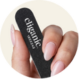 A close-up of a hand holding a black nail file labeled 'climac' against a white background.