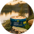 Cliganic Mosquito Repellent Candle with citronella and essential oils beside a peaceful lakeside setting.