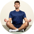 Man meditating in a seated yoga pose, representing calm and focus.