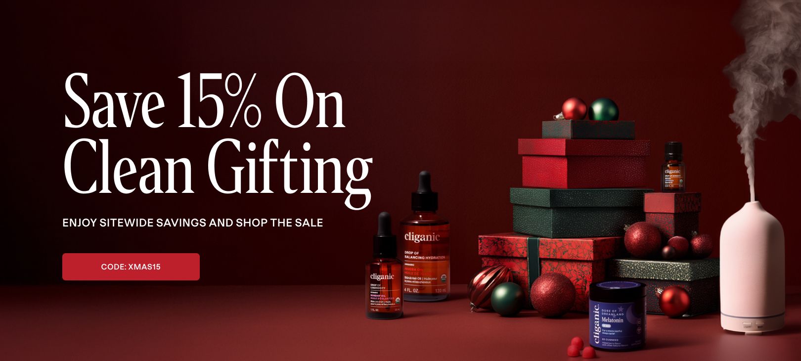 Promotional banner for 'Save 15% On Clean Gifting' with gift boxes, skincare products, and a diffuser on a dark red background.