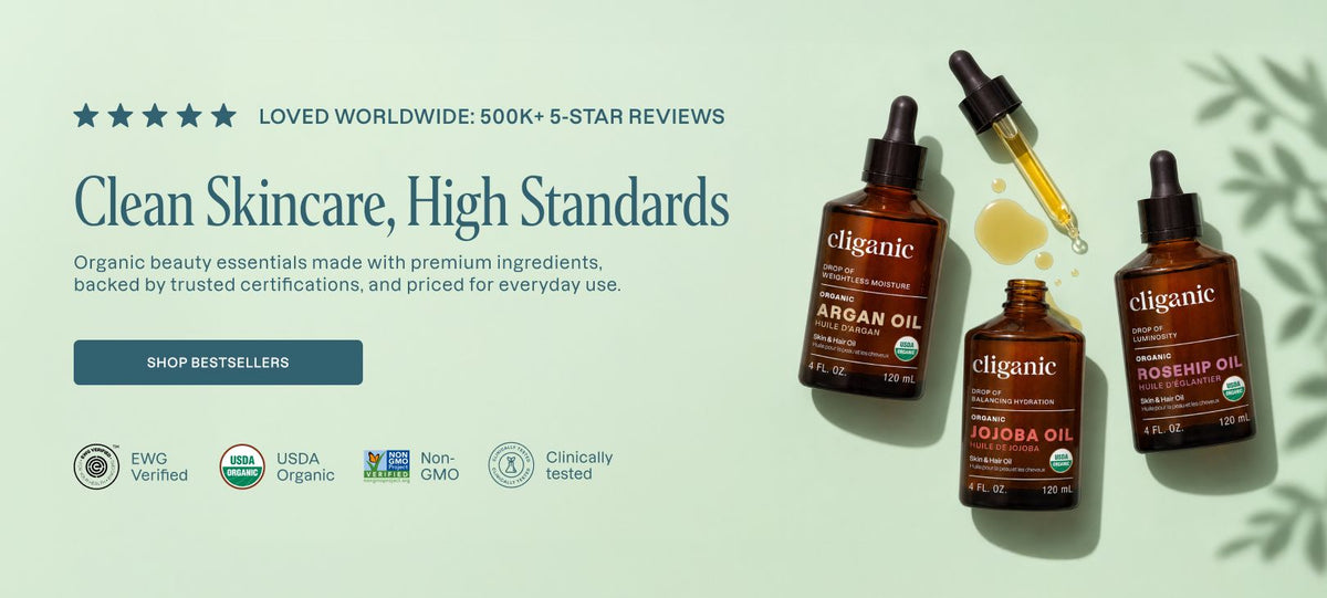 Three amber glass dropper bottles of eliganic skincare oils on a pale green background with promotional text, star reviews, and certification icons. The bottles include Argan Oil, Rosehip Oil, and Jojoba Oil.