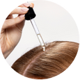 Cliganic hair serum applied to blonde hair with a dropper for lightweight nourishment and shine.